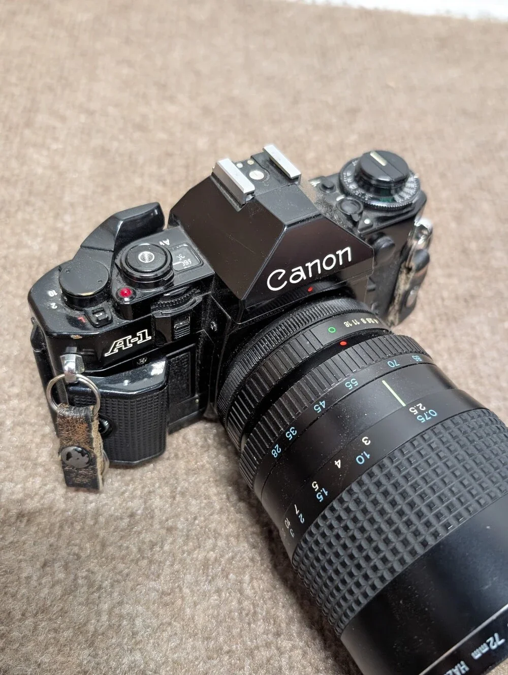 Vintage Canon A-1 Black SLR Camera with Black Lens and Black Flash